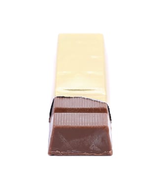 Chocolate bar in golden foil. Isolated on a white background.