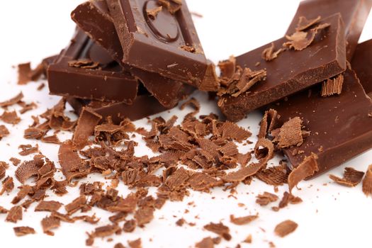 Chocolate bars and shaving on a white background
