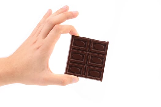 Hand holds chocolate bar. Isolated on a white background.