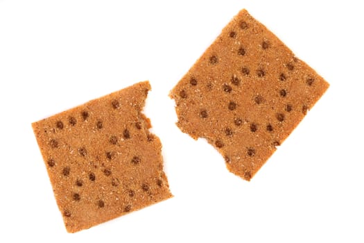 Broken whole grain crisp bread. White background.