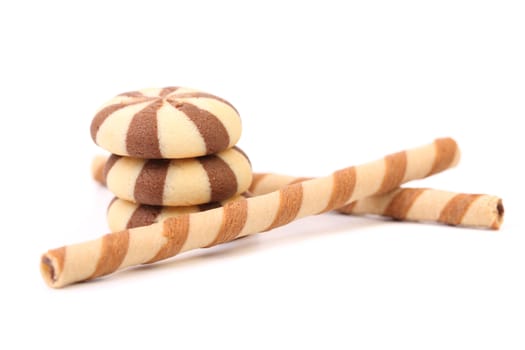 Chocolate striped wafer rolls and stake biscuits. White background.