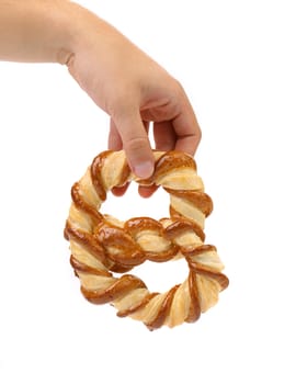 Hand holds freshly fancy pretzel baked. White background.