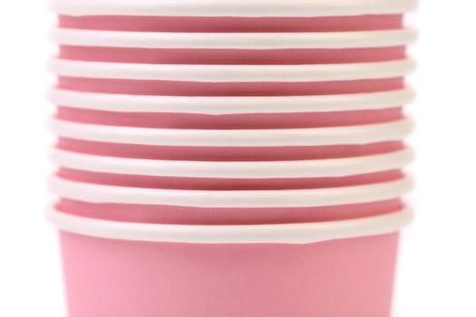 Pile of colorful paper coffee cup. Close up. White background.