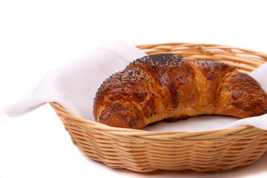 Image of croissant with poppy in a basket. White background.
