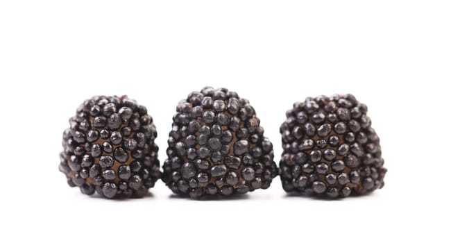 Three black jujube colored balls on a white background