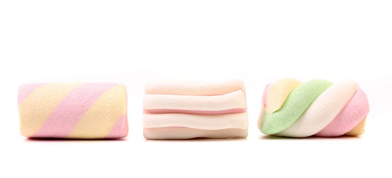 Three different colorful marshmallow. Close up. White background.