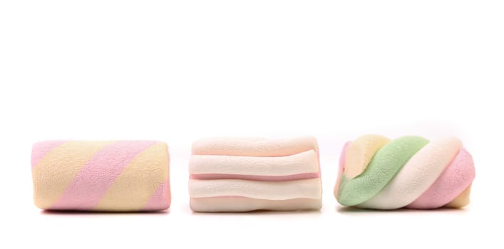 Three colourful marshmallow. Close up. White background.