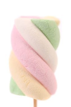 One colourful marshmallow on a stick. Close up. White background.