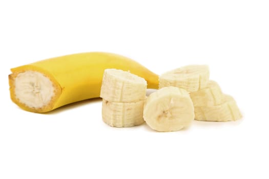 Half of banana and slices. White background.