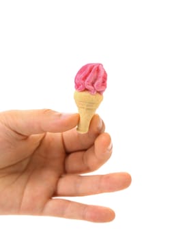 Hand holds arshmallow in form of ice cream. White background.
