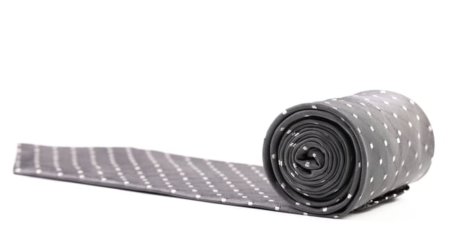 Folded gray tie with white speck. White background.
