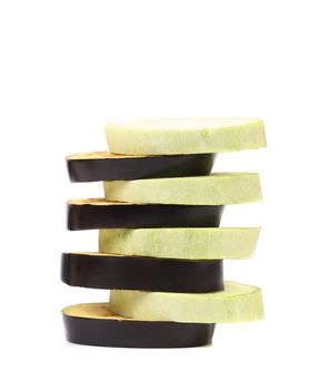 Stack of slices black eggplant. White background.