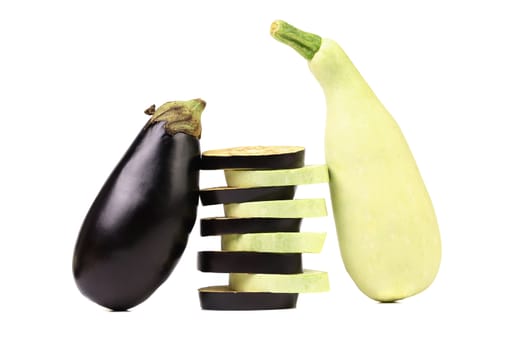 Stack of slices. Zucchini and black eggplant. White background.