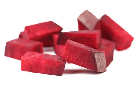 Fresh segments of a beet on a white background.