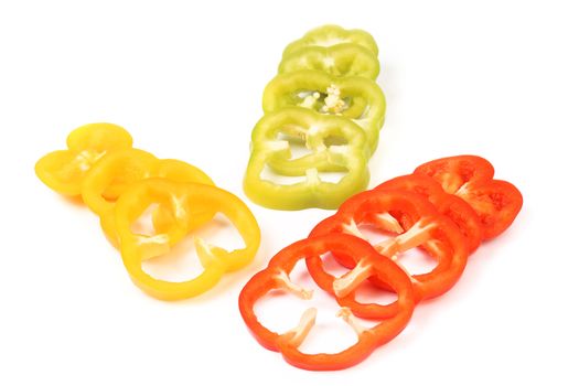 Multi-colour slices of peppers isolated on a white background.
