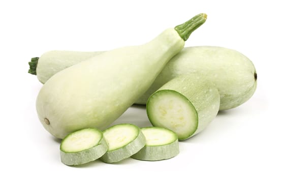 Fresh marrow vegetable and slices. White background.