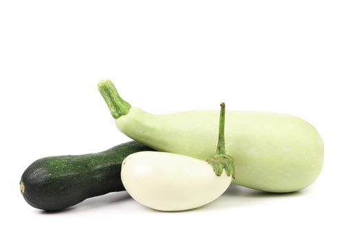 Vegetable marrows and white eggplant on a white background.