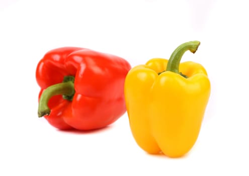 Red and yellow peppers with tails on a white background.