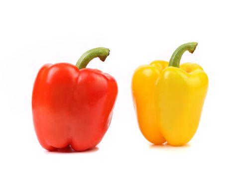 Red and yellow peppers with tails on a white background.
