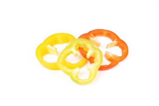 Multi-colour slices of peppers isolated on a white background.