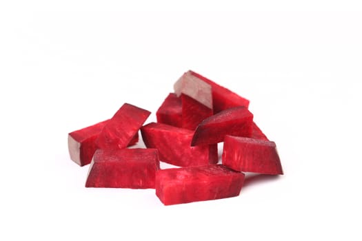 Fresh segments of a beet on a white background