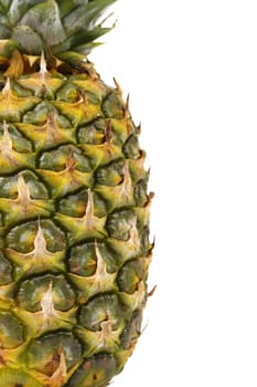 Pineapple is located half of a white background. Close up.