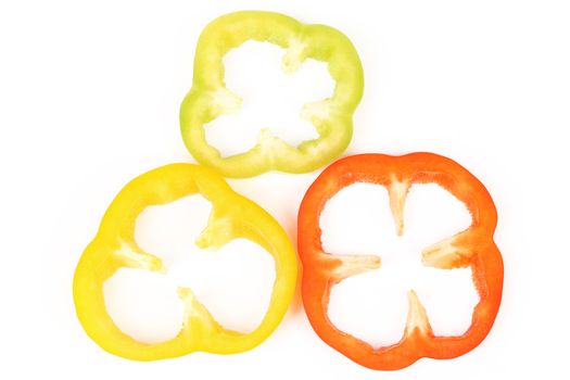Multi-colour slices of peppers isolated on a white background.