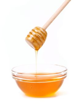 Bee honey with wooden dipper. Honey's dessert - honey stick on golden background.