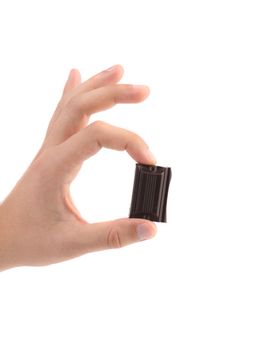 Hand holds chocolate bar. Close up. White background.