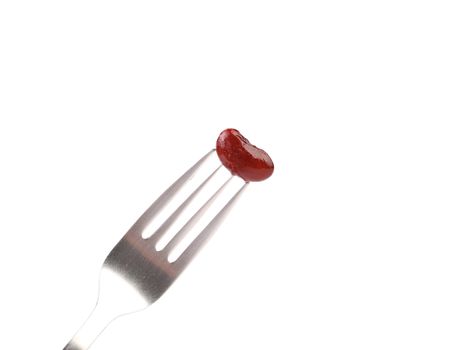 Single canned bean on fork isolated on a white background