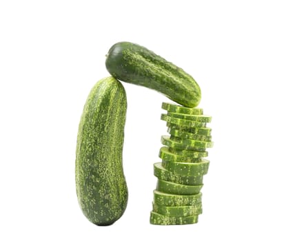 Arch. Cucumbers and stack of slices. White background.