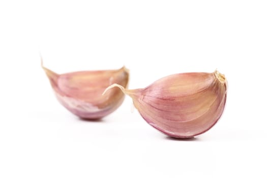 Fresh cloves of garlic isolated on a white background.