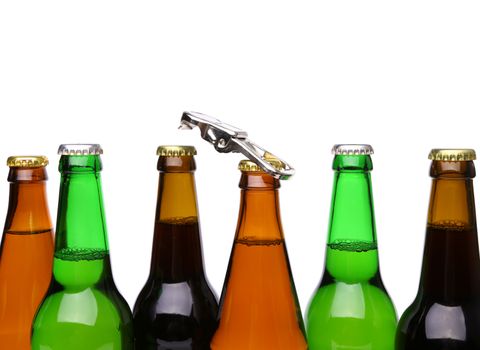 Top bottles of beer and a opener. White background.