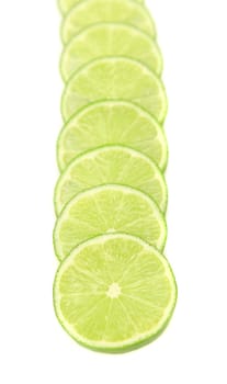 Row lime slices on a white background