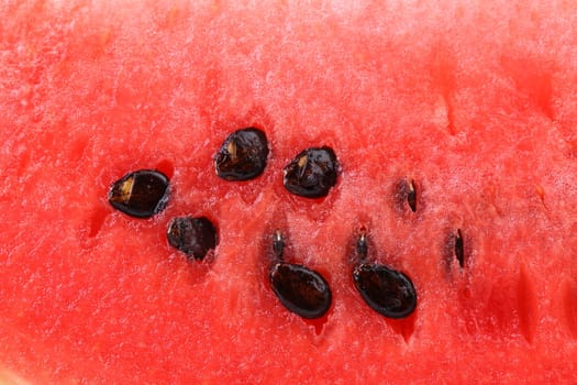 Macro shot of a watermelon with its seeds. Whole background.