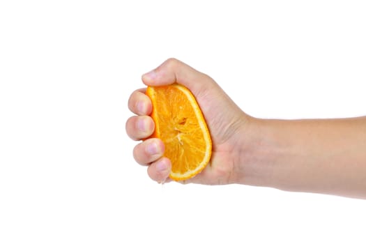 Hand squeezing an orange isolated on a wite background