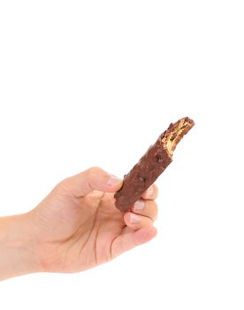 Hand holds bitten chocolate bar. White background.