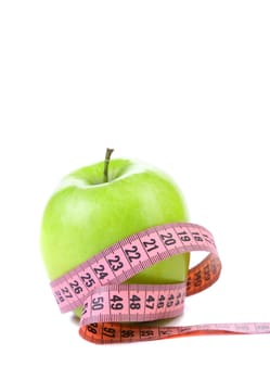 fresh apple with measuring tape. isolated over white background