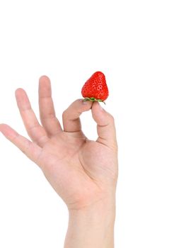 hand holds a strawberry. Isolated on a white background.