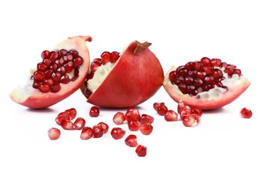 Opened pomegranate and seeds isolated on a white background.