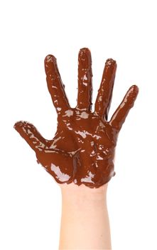 Children's hand stained with thick chocolate frosting. White background.