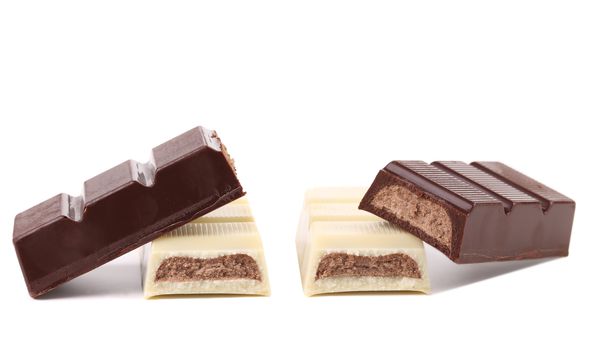 Black and white chocolate bars with filling. White background.