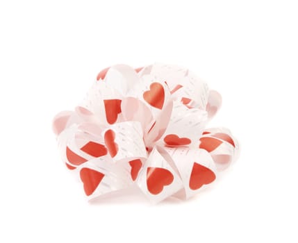 White bow with red hearts. White background.