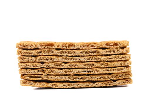 Stack of whole grain crisp bread. White background.