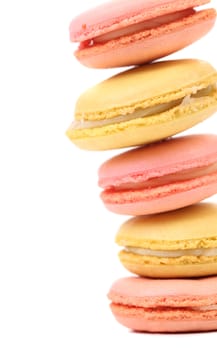 Stack of traditional French macarons against a white background.