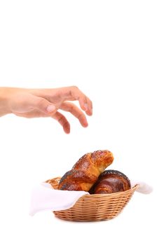 Hand reaching for croissants. Close up. White background.