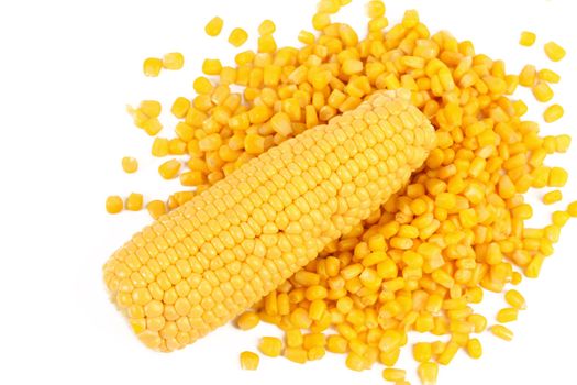 Corncob on a bulk of corn grains. White background.