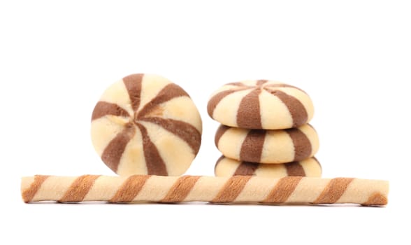 Striped chocolate wafer rolls and stake biscuits. White background.