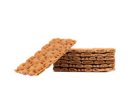Stack of whole grain crisp bread. White background.