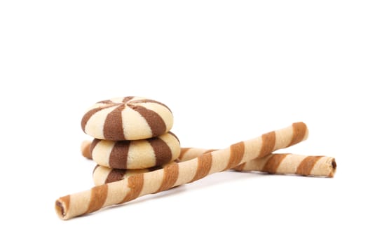 Striped chocolate wafer rolls and stake biscuits. White background.